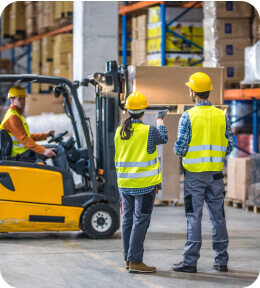 employees in safety vests in a warehouse