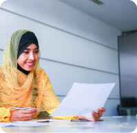 woman looking over a piece of paper