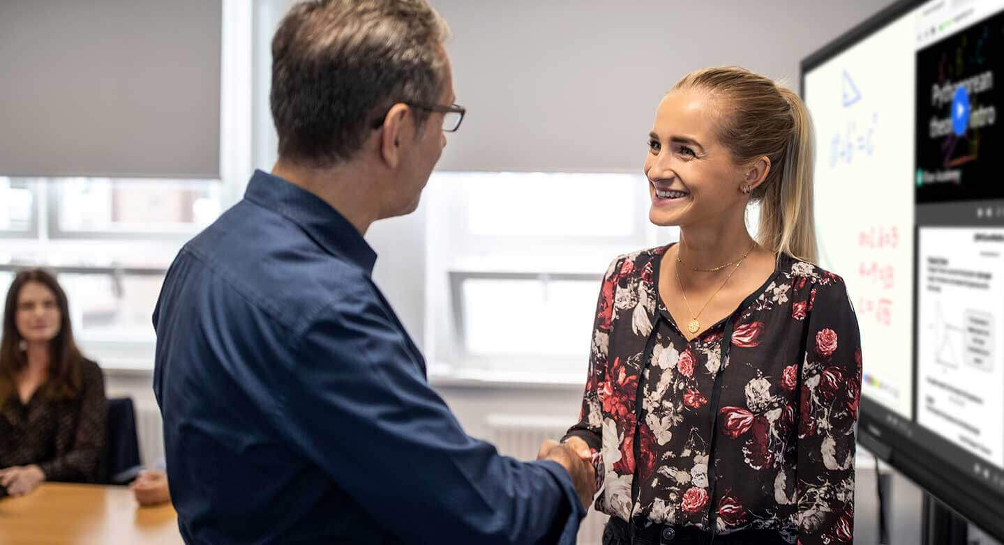 two colleagues shaking hands.