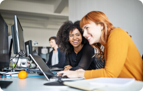 two coworkers smiling 