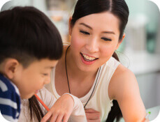 teacher helping elementary student