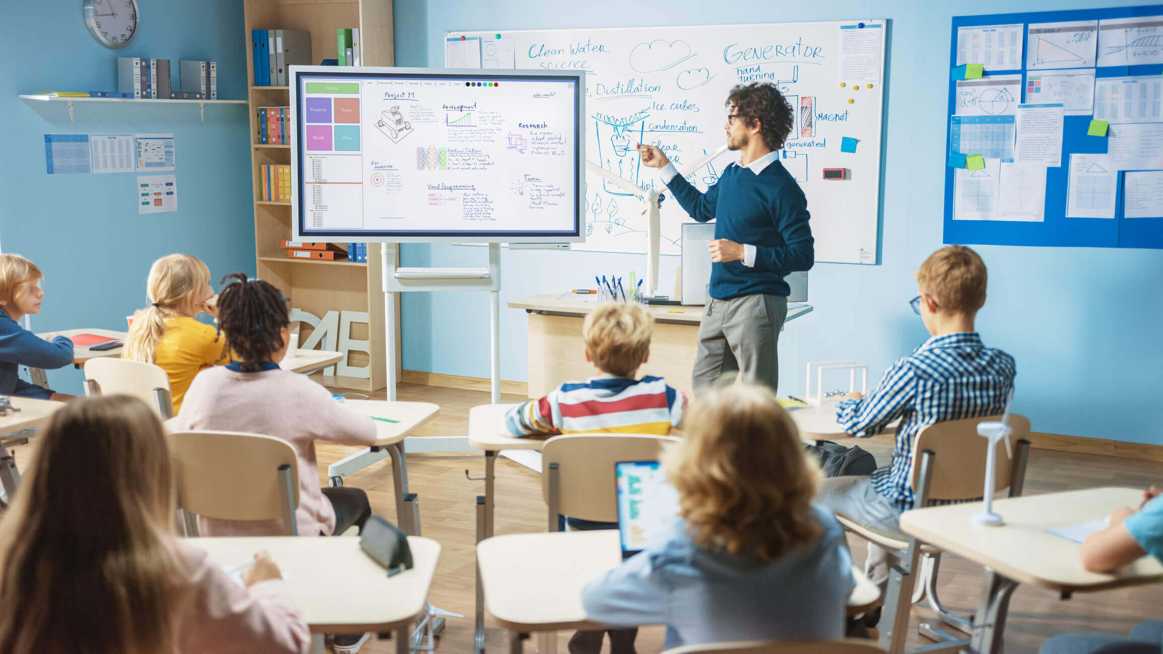 Teacher uses interactive whiteboard to engage students in lesson