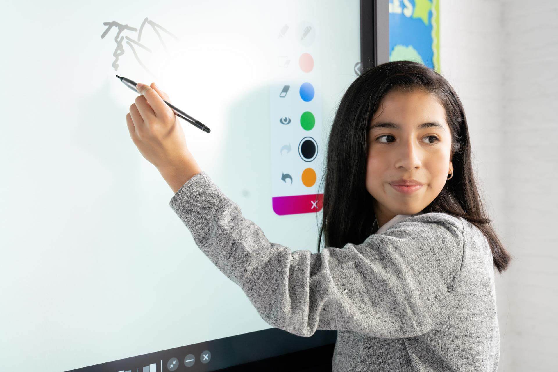 Students using an interactive whiteboard in the classroom