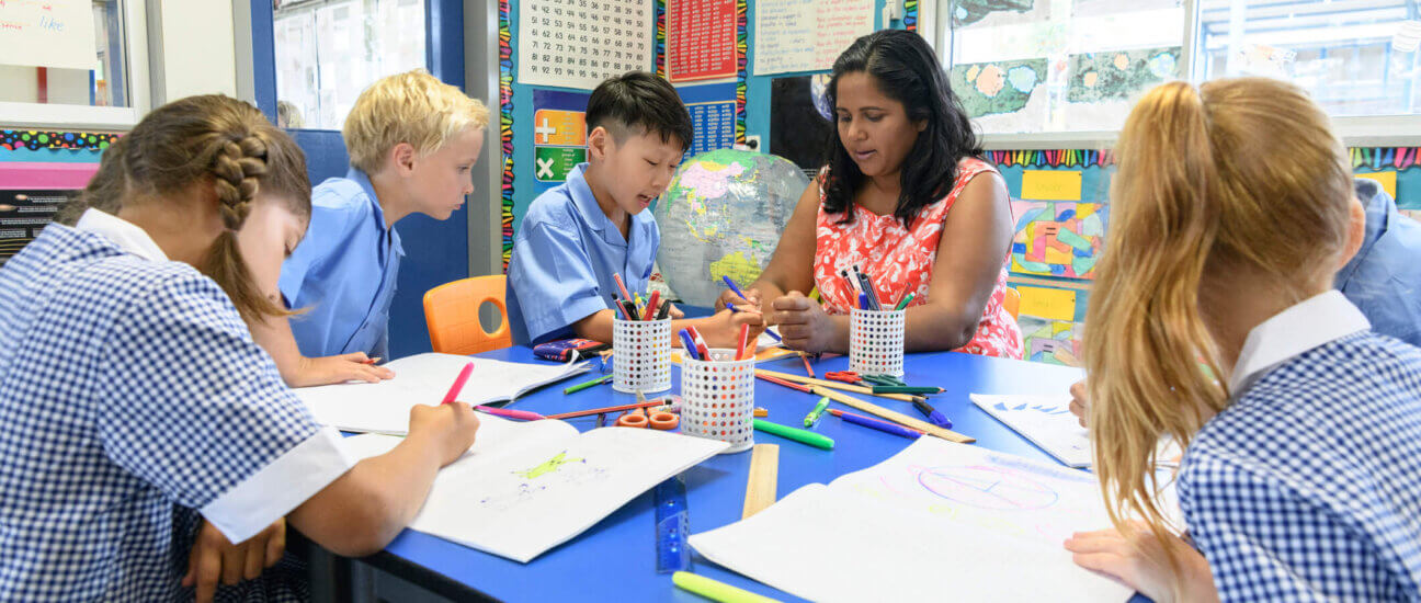 classroom students working on an art project with the teacher