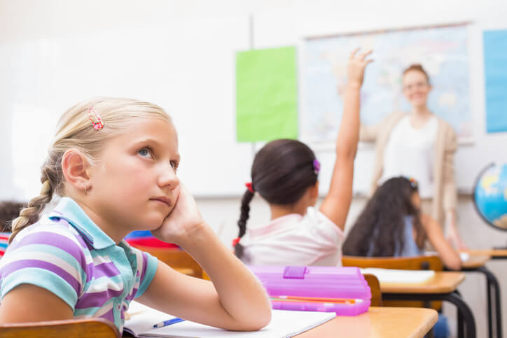 Student looking away from teacher in class "zoning" out. 