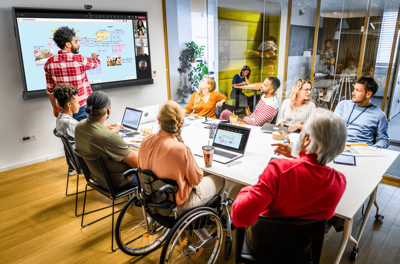 people in a meeting interacting with the Promethean panel