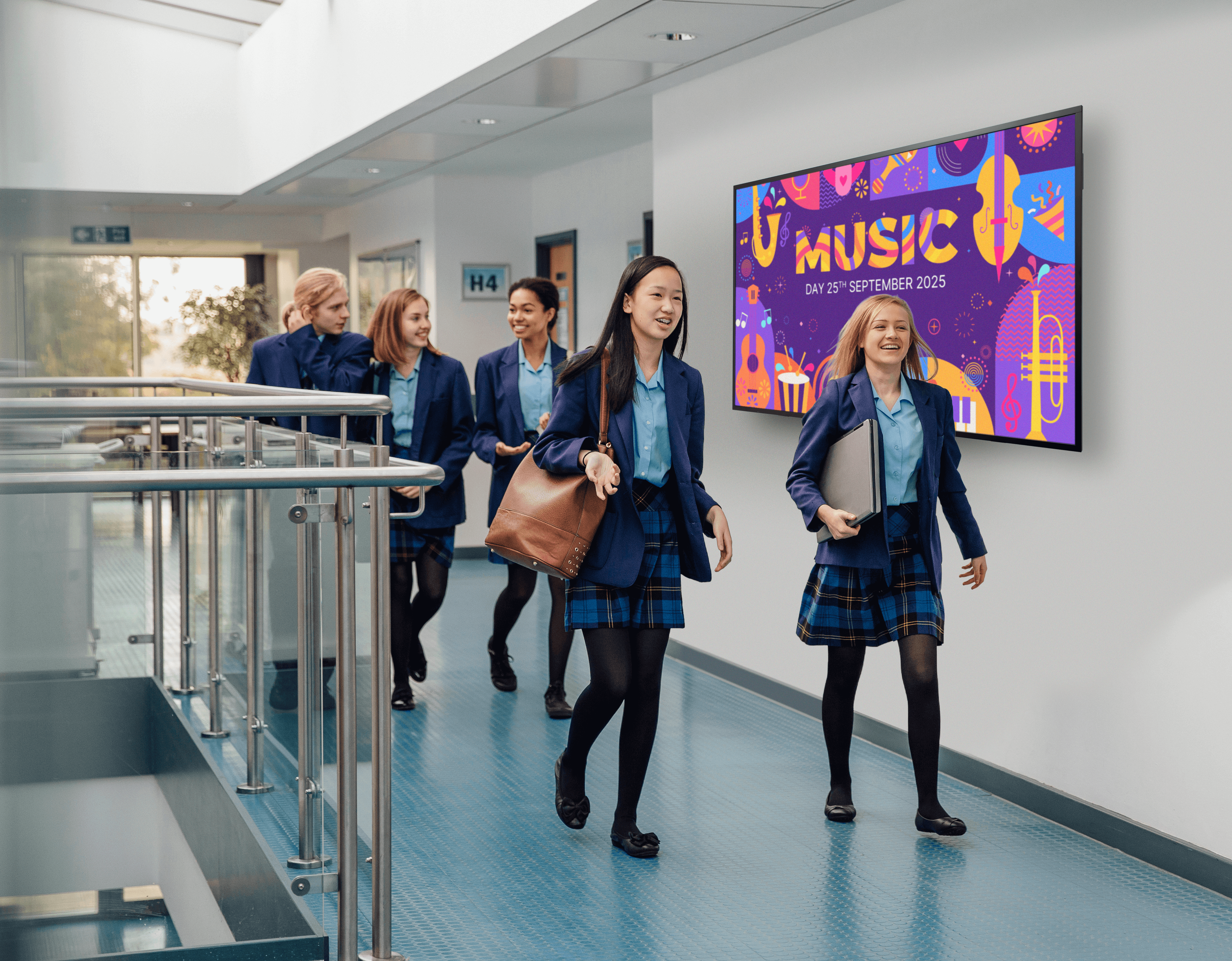 Students walking in a hallway with the ActivPanel D-Series mounted on wall